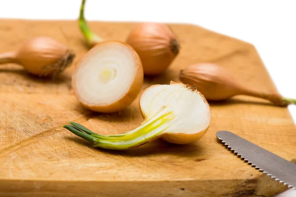Onions on wooden board — Stock Photo, Image