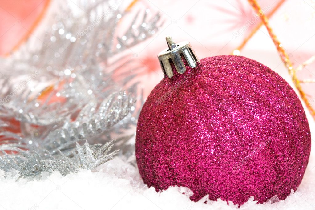 Pink Christmas balls on snow background