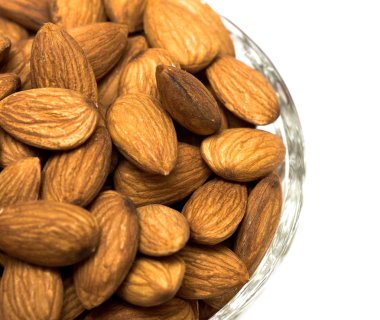 Many almonds nuts in glass bowl
