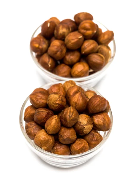 Many hazelnuts in glass bowls — Stock Photo, Image