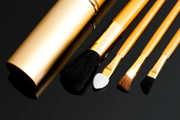 Cosmetic brushes on black background — Stock Photo, Image