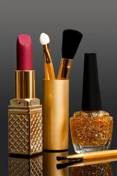 Lipstick; enamel and cosmetic brushes — Stock Photo, Image