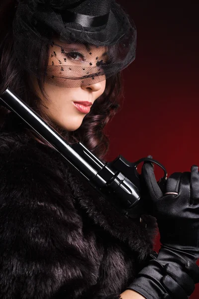 Elegant dam med en pistol i händer — Stockfoto