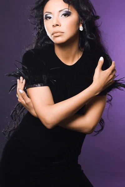 Sexy fashionable mulatto woman on violet — Stock Photo, Image