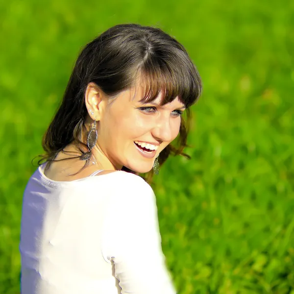 Sonrisa adolescente sentado en el parque de primavera —  Fotos de Stock
