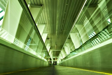 Dark green moving escalator in the metro station clipart