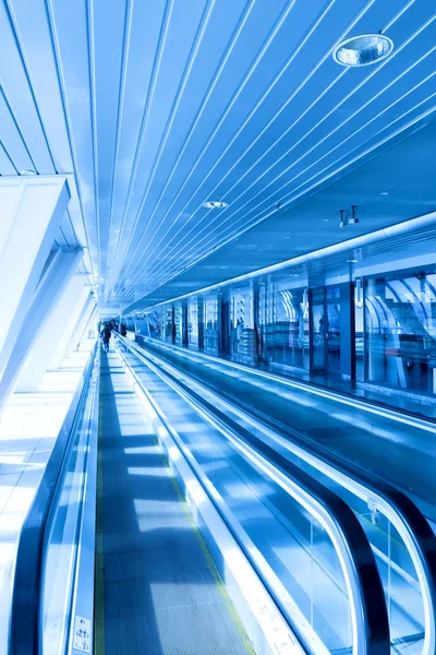 Fast moving escalator by motion Stock Picture