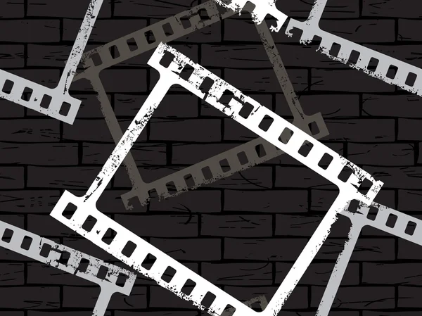 Mur grunge avec bande de film — Image vectorielle