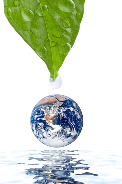 stock image Water drop falling onto earth planet isolated