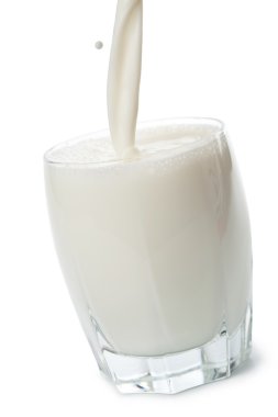 Milk pouring into glass isolated clipart