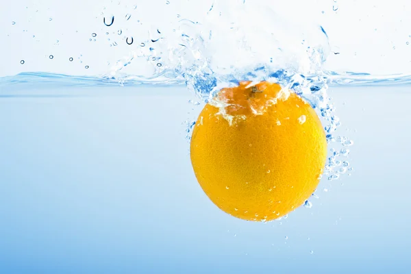 stock image Lemon splashing into blue water