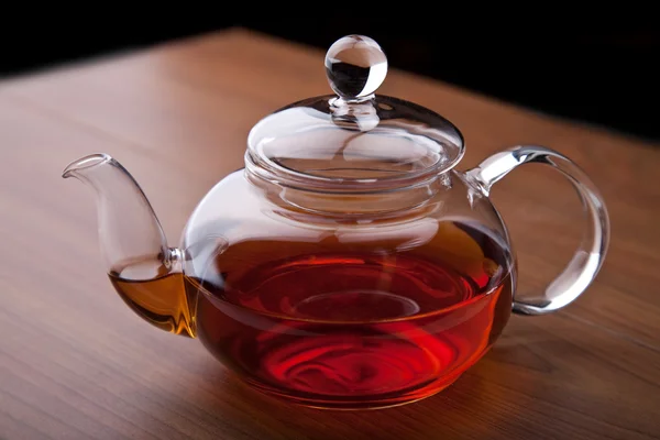 Glass teapot with black tea — Stock Photo, Image