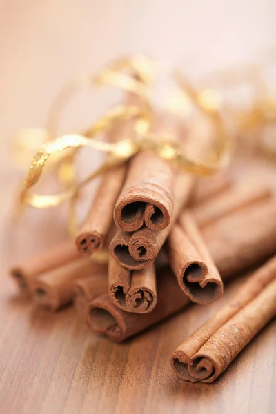 stock image Cinnamon with golden ribbon