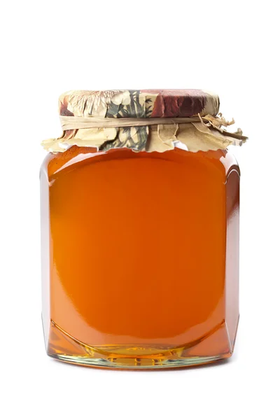 Fles van honing geïsoleerd — Stockfoto