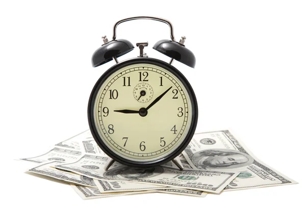 Alarm clock over heap of money isolated — Stock Photo, Image