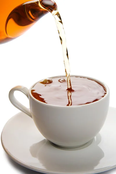 Tee in weiße Tasse gießen isoliert — Stockfoto