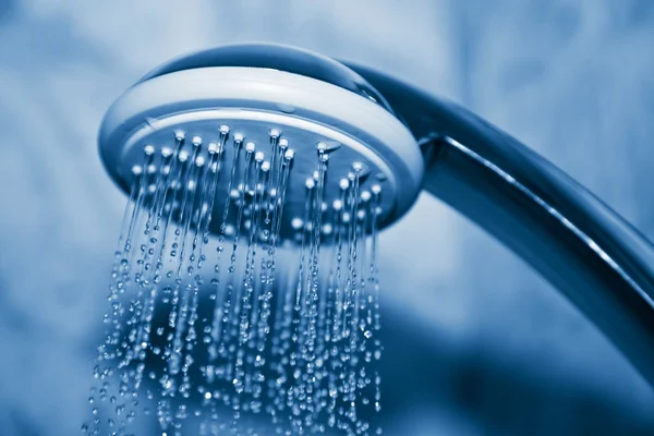 Water flowing from metal shower — Stock Photo, Image