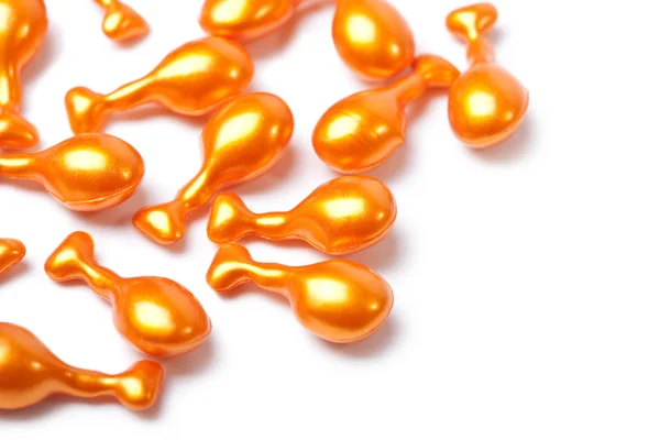 Orange kosmetiska kapslar isolerade — Stockfoto