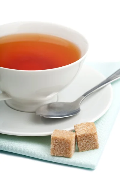 Cup of tea and cane sugar isolated — Stock Photo, Image