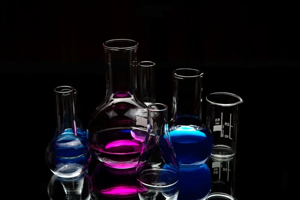 Chemical laboratory equipment over black — Stock Photo, Image