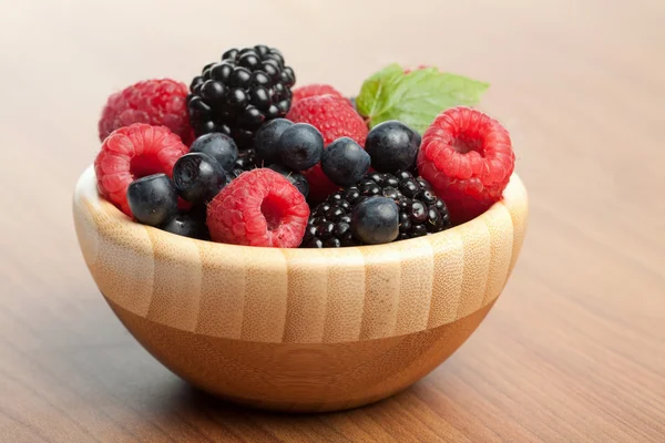 Fresh berries in wood bowl — Stock Photo, Image