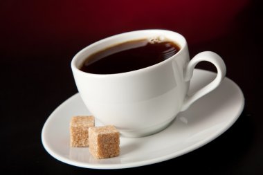 Cup of coffee over black background