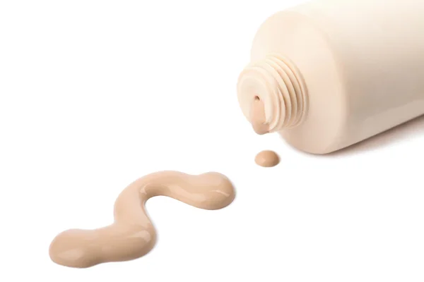 Liquid foundation spilled out of bottle isolated — Stock Photo, Image
