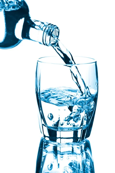 Wasser spritzt isoliert ins Glas — Stockfoto