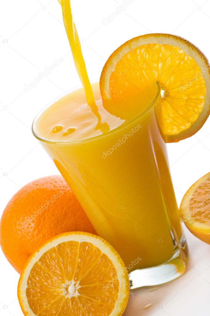 Orange juice pouring into glass isolated