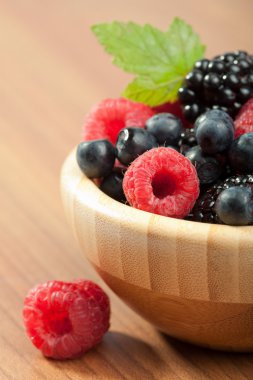 Fresh berries in wood bowl clipart