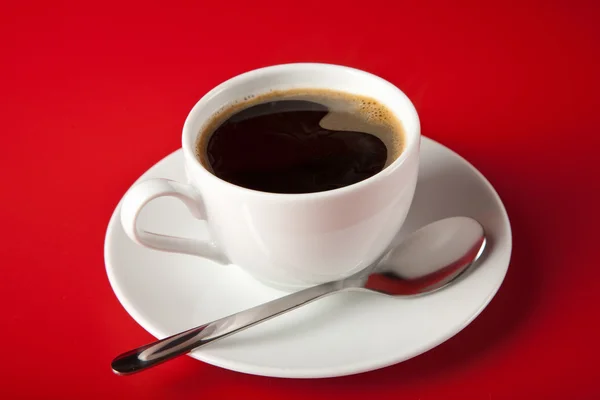Cup of coffee over red background — Stock Photo, Image