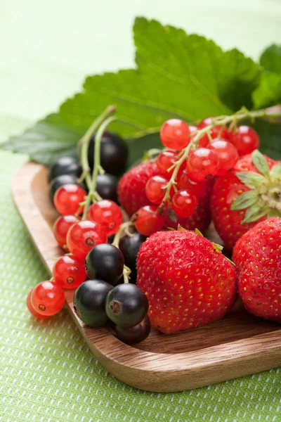 Fresh berries in wooden bowl — Stock Photo, Image