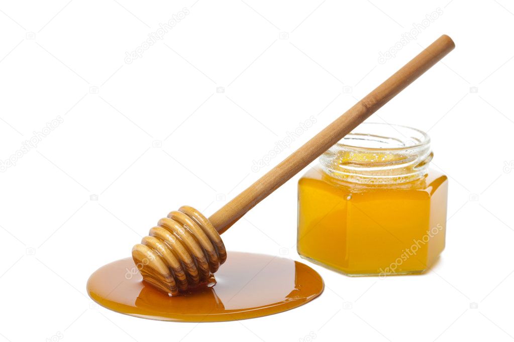 Wooden dipper with honey and bottle isolated