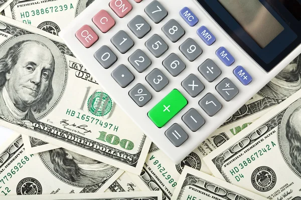 Dólares e calculadora — Fotografia de Stock