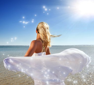 Blond woman with white shawl relaxing near the sea clipart