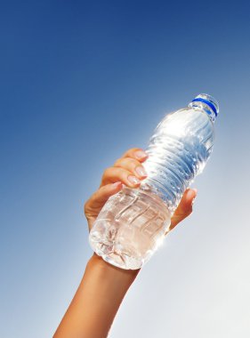 Human hand holding a bottle of water clipart