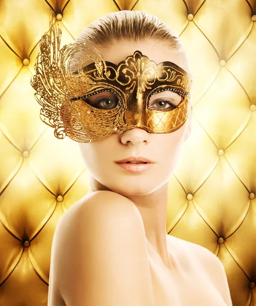 Beautiful woman in carnival mask over abstract background — Stock Photo, Image