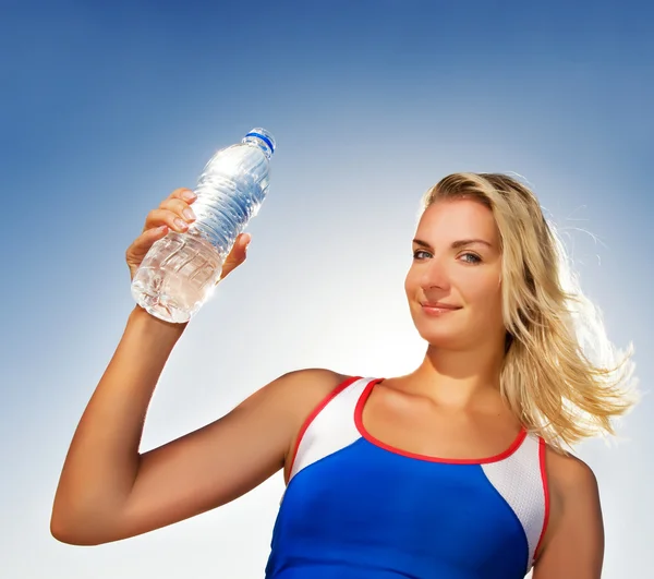 Mladá žena pitná voda po fitness cvičení — Stock fotografie