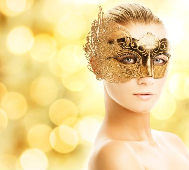 Beautiful young woman in carnival mask clipart