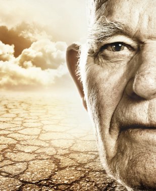 Elderly man's face over dry desert land background clipart