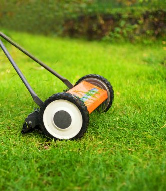 Lawnmower cutting grass clipart