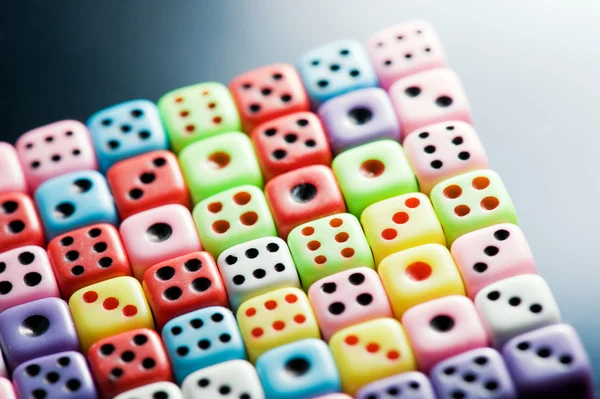 Plastic colorful dices over glass surface — Stock Photo, Image