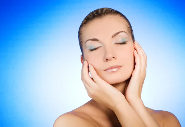 Beautiful Young Woman Massaging Her Face Stock Photo