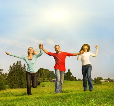 Three happy friends running outdoors clipart