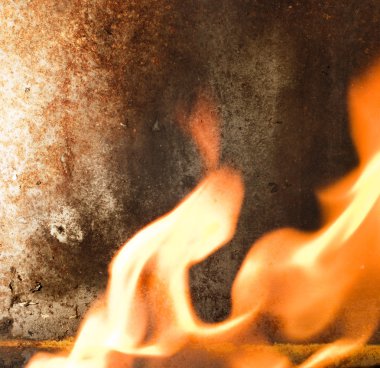 Rusty metal texture and flames of fire around it clipart