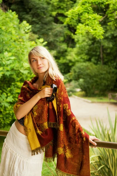 Güzel genç kadın rahatlatıcı bir parkta — Stok fotoğraf