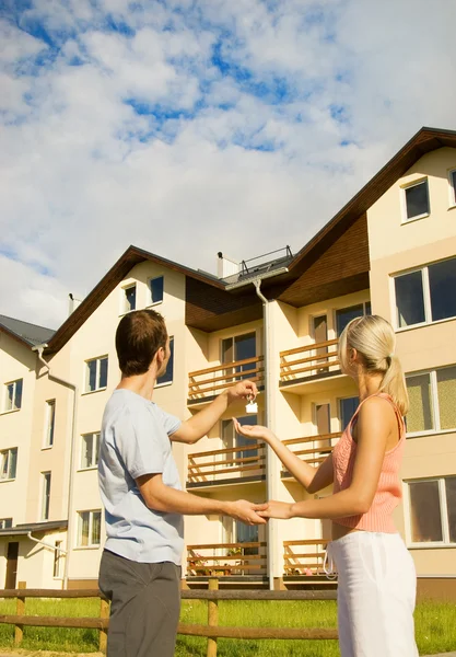 Man giving keys from the house to the woman Stock Photo
