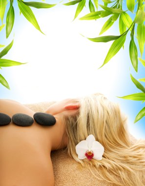 Massage with hot volcanic stones clipart