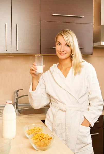 Красива молода жінка п'є молоко вранці — стокове фото