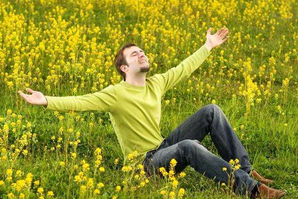 Happy Young Man Sitting Flower Field — Stock Photo, Image